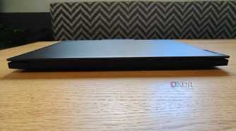 Front view of the ThinkPad P16 Gen 7 laptop on a table with a stiped couch in the background