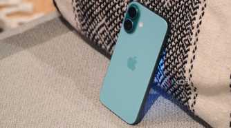 The iPhone 16 leaning against a pillow.