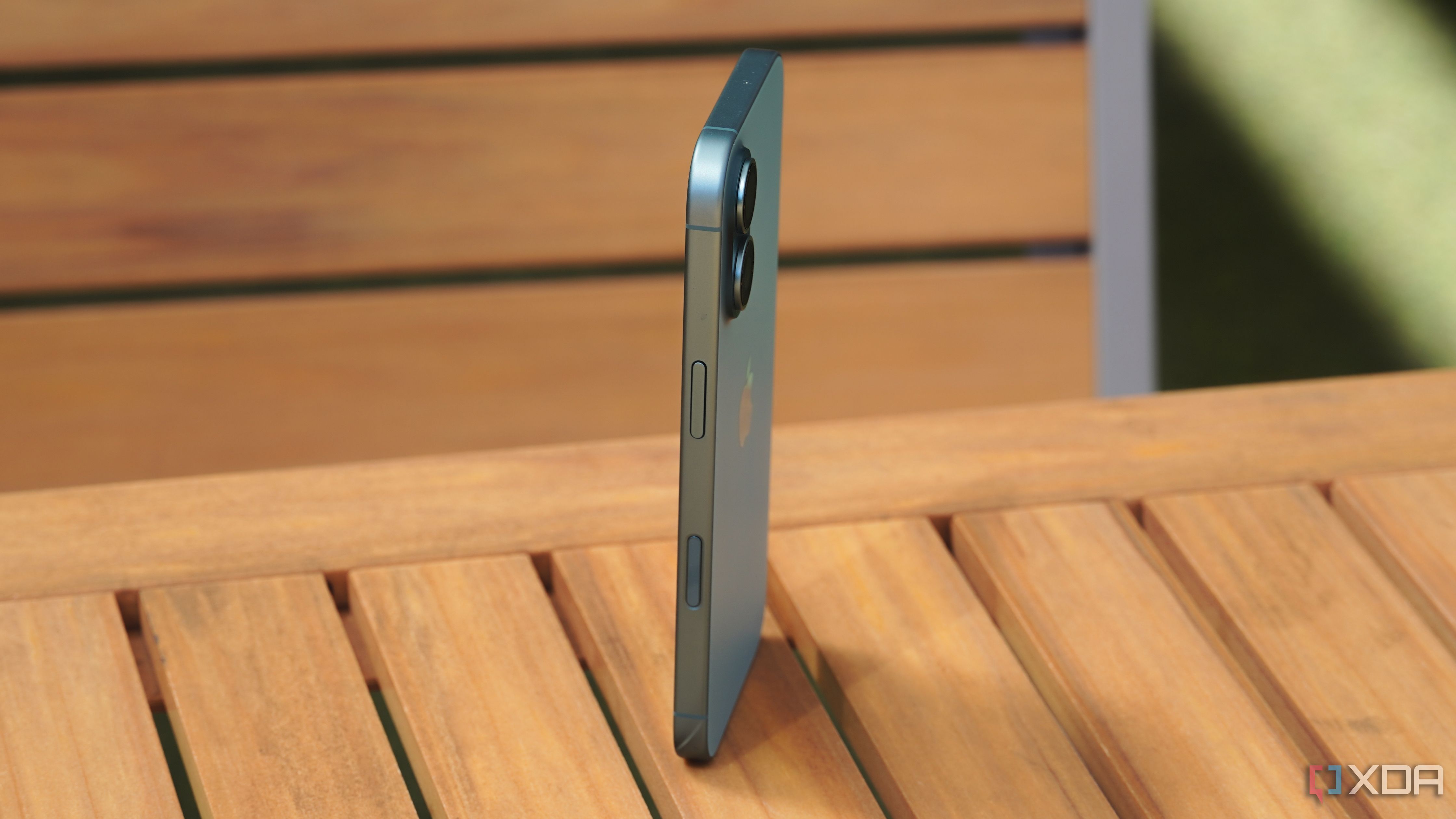 A side view of the iPhone 16 standing up.