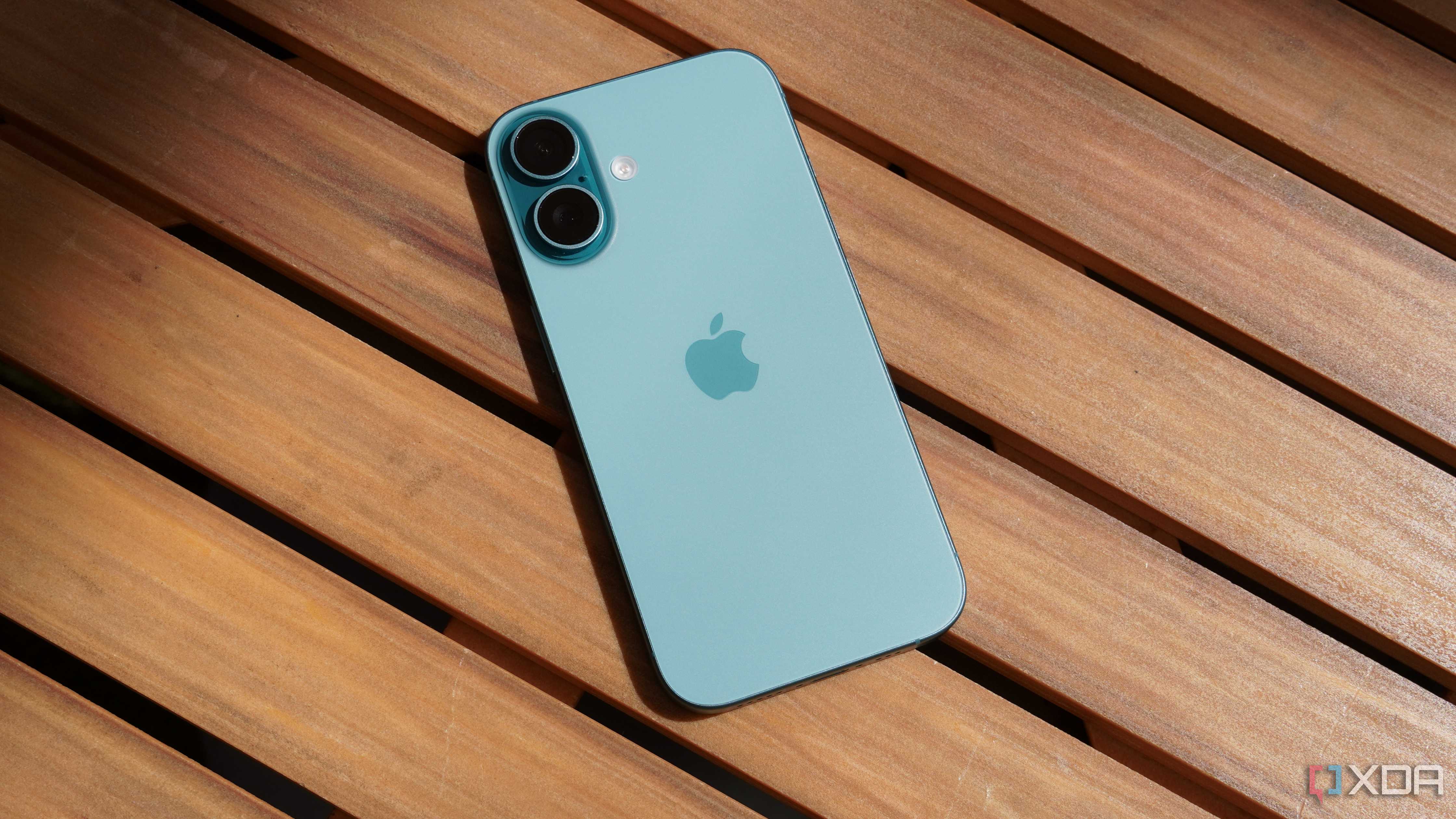 The iPhone 16 on a table outdoors.