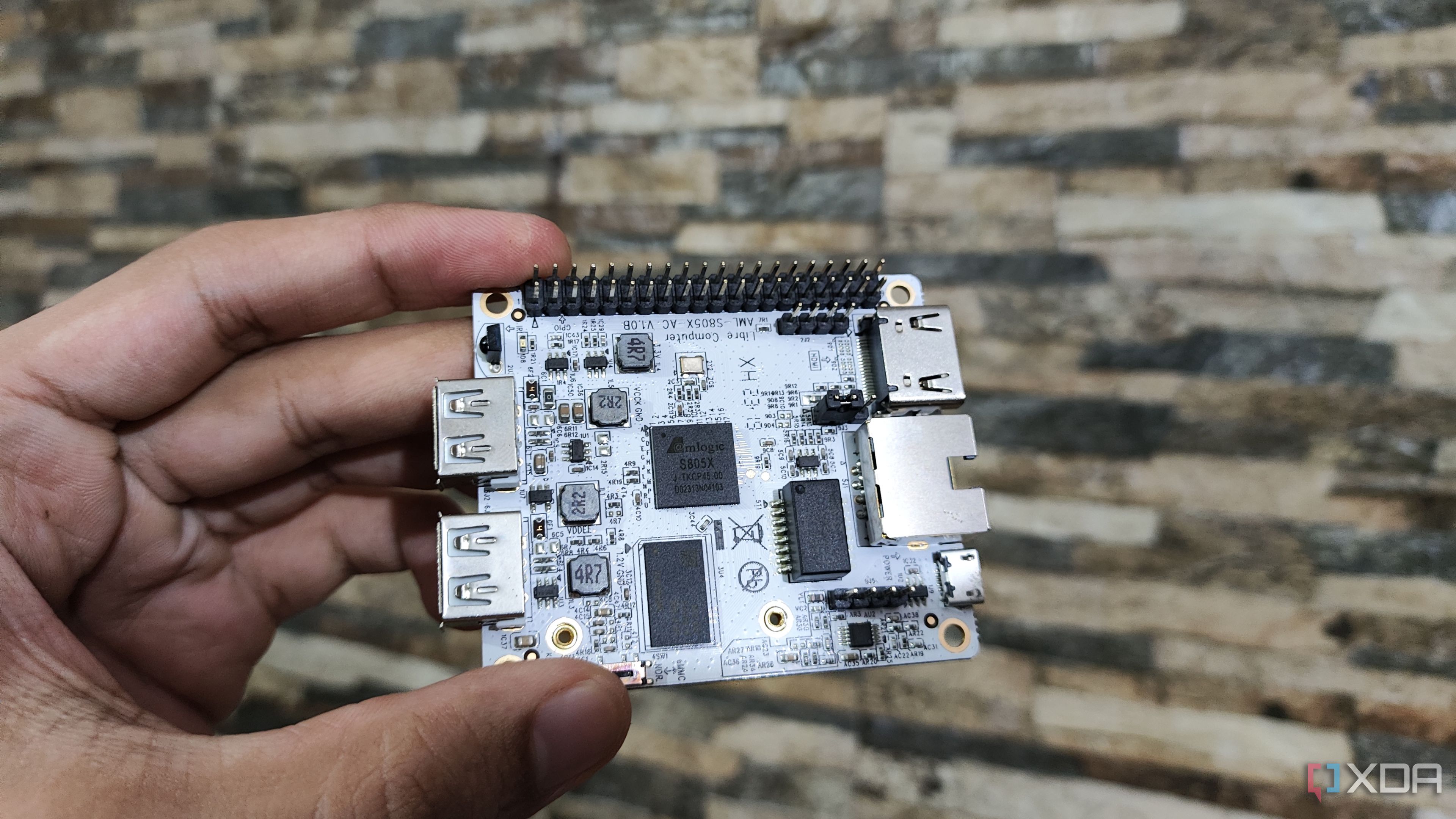 A person holding the Libre Computer La Frite AML-S805X-AC SBC