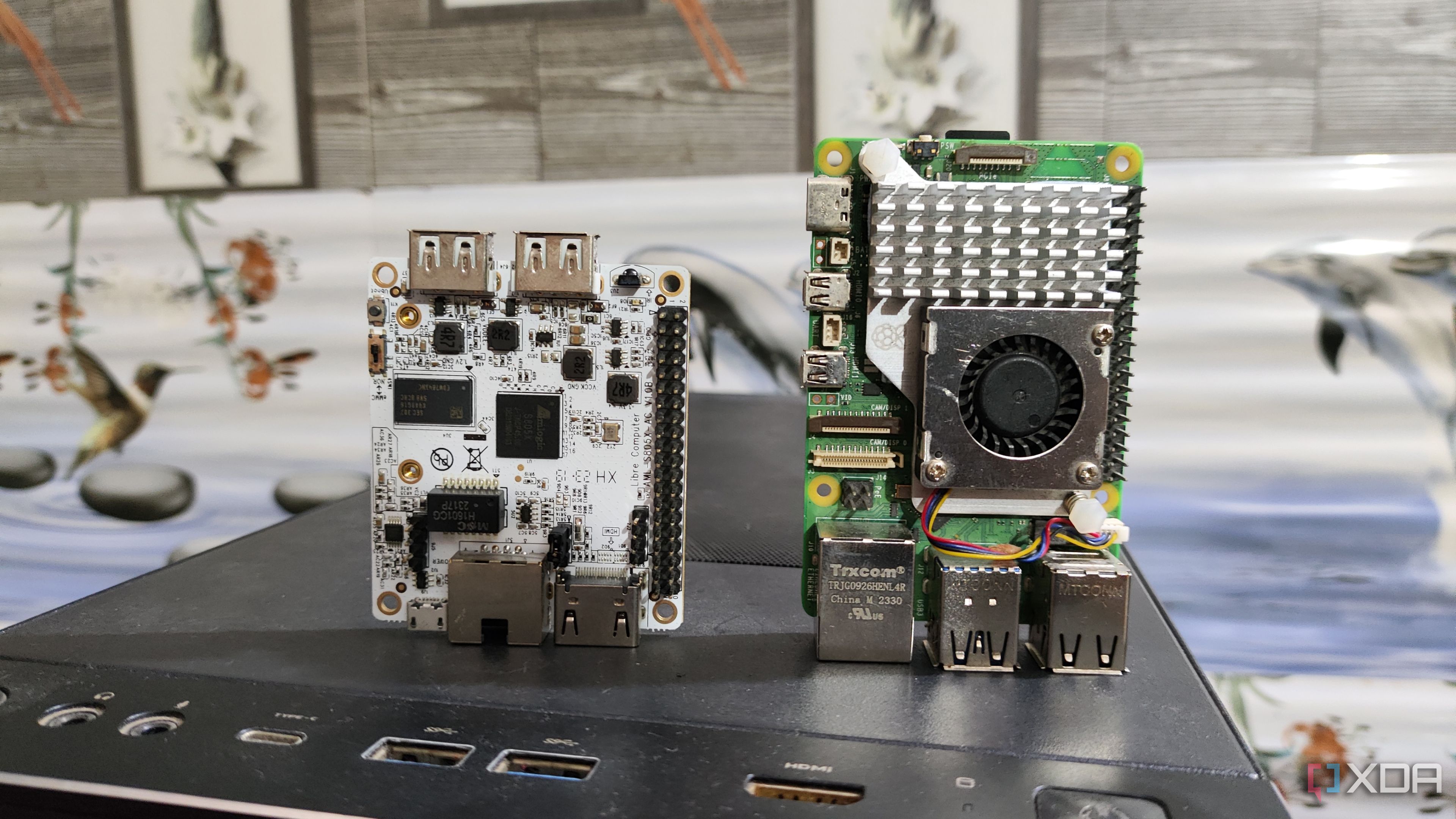 A Libre Computer La Frite AML-S805X-AC SBC placed near a Raspberry Pi 5