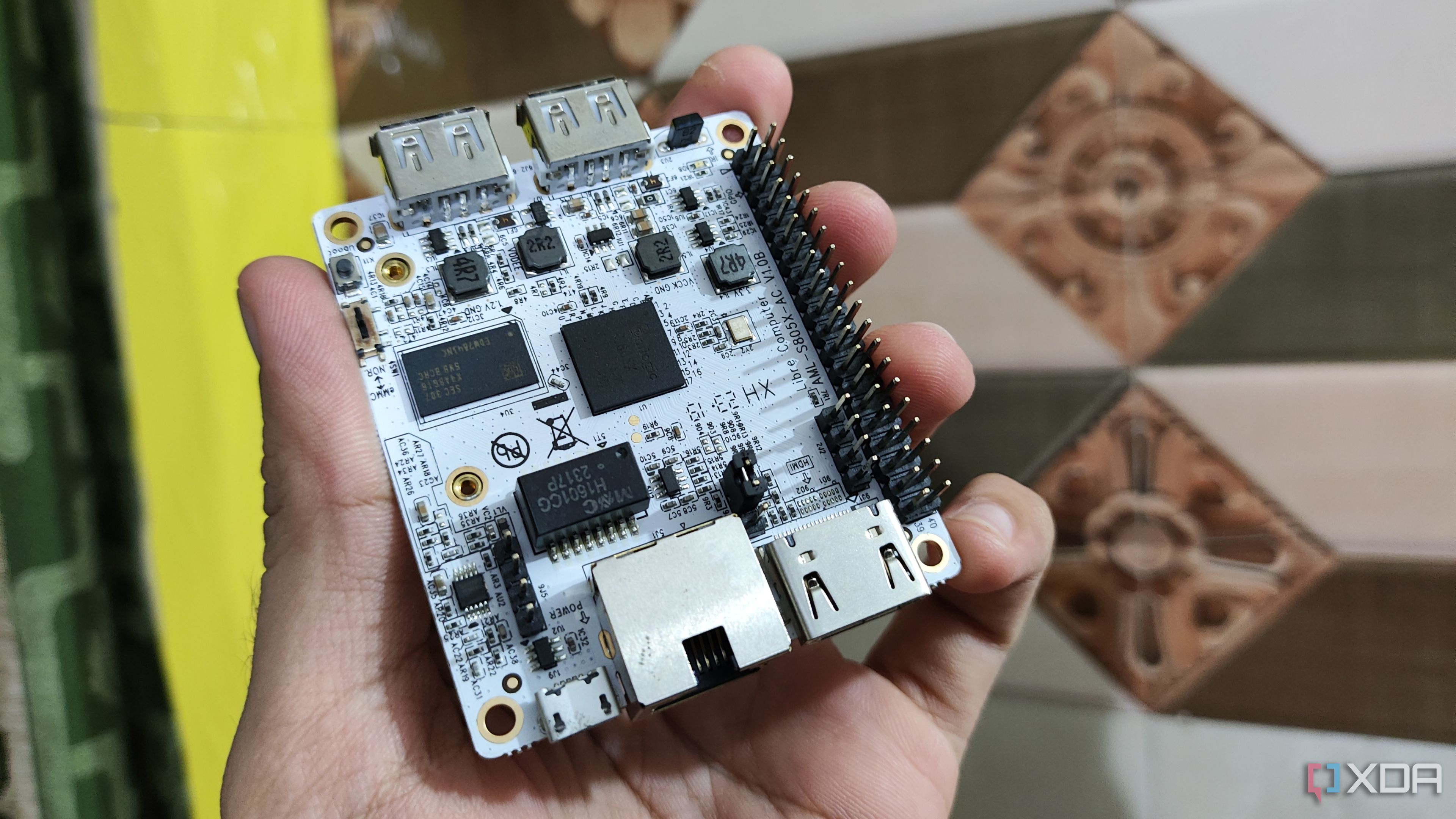 A person holding a Libre Computer La Frite AML-S805X-AC SBC