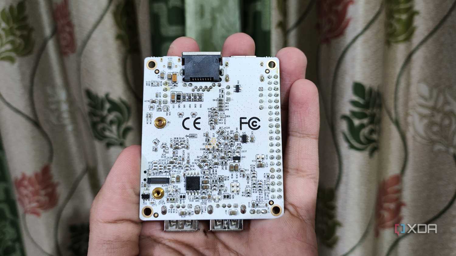 A person holding a Libre Computer La Frite AML-S805X-AC SBC