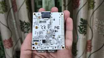 A person holding a Libre Computer La Frite AML-S805X-AC SBC