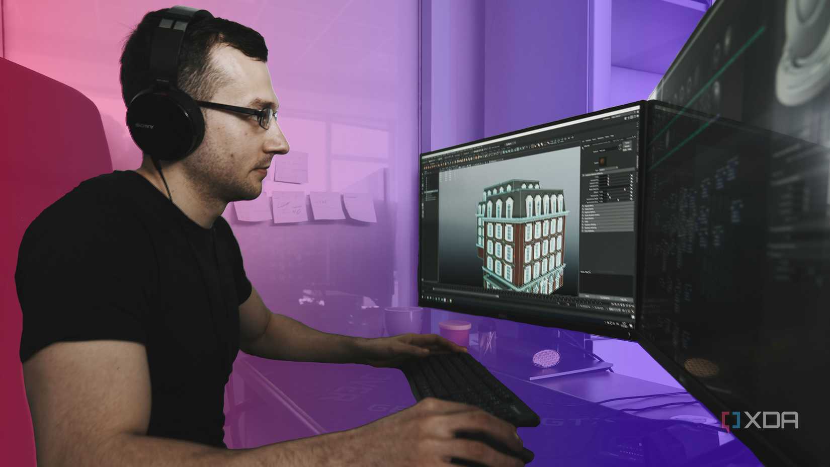 A man using a computer wit multiple monitors