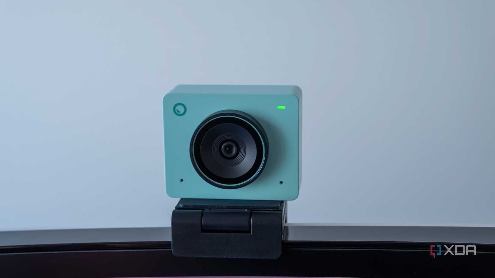 An Obsbot Meet 2 in Aurora green mounted on a monitor