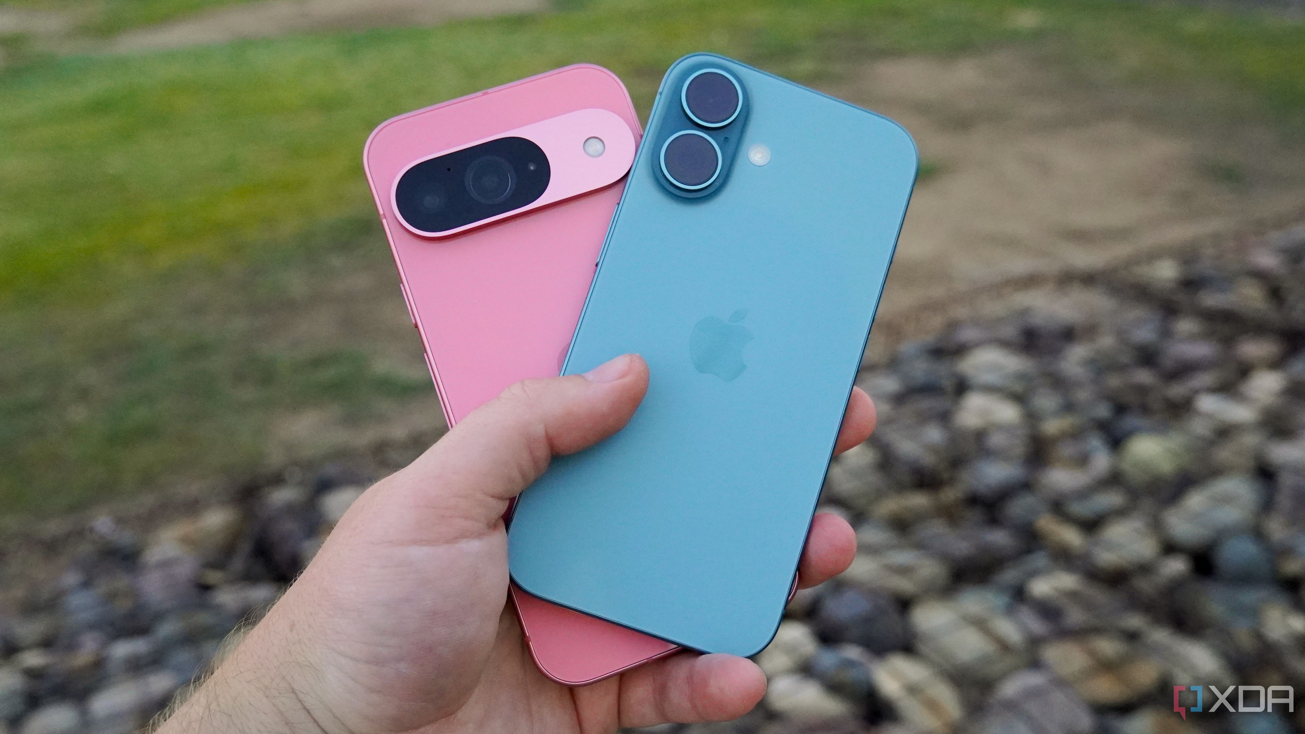 Holding the Pixel 9 and iPhone 16 in the hand.