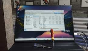 The Proxmox UI running on a portable monitor with two screwdrivers resting against it