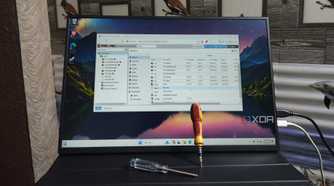 The Proxmox UI running on a portable monitor with two screwdrivers resting against it