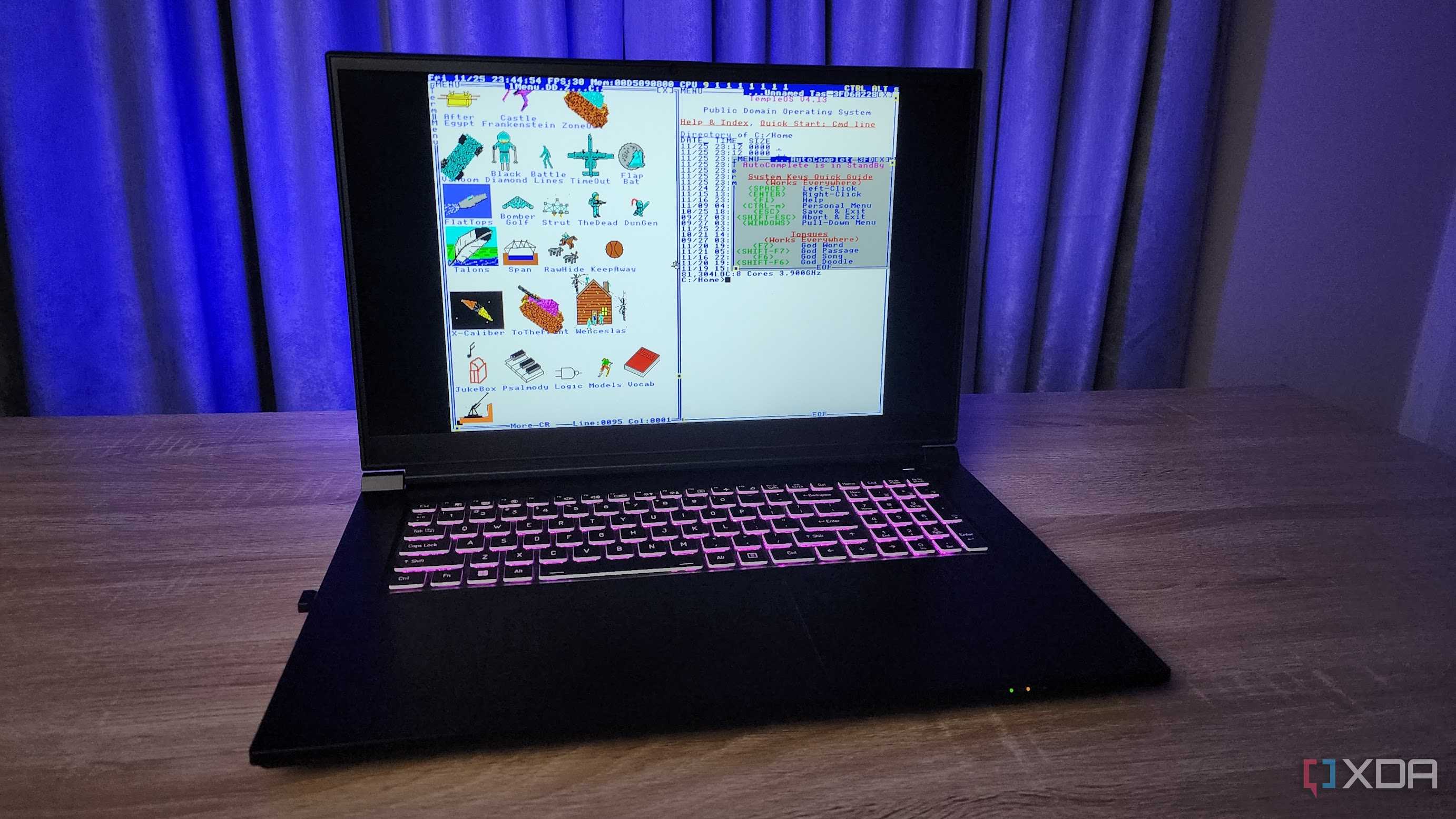 A screenshot of TempleOS displayed on a modern laptop.