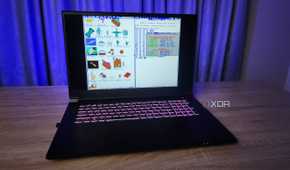 A screenshot of TempleOS displayed on a modern laptop.