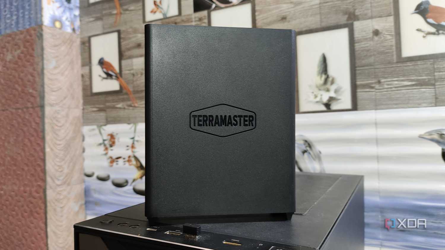 A TerraMaster F8 SSD Plus NAS placed on top of a PC