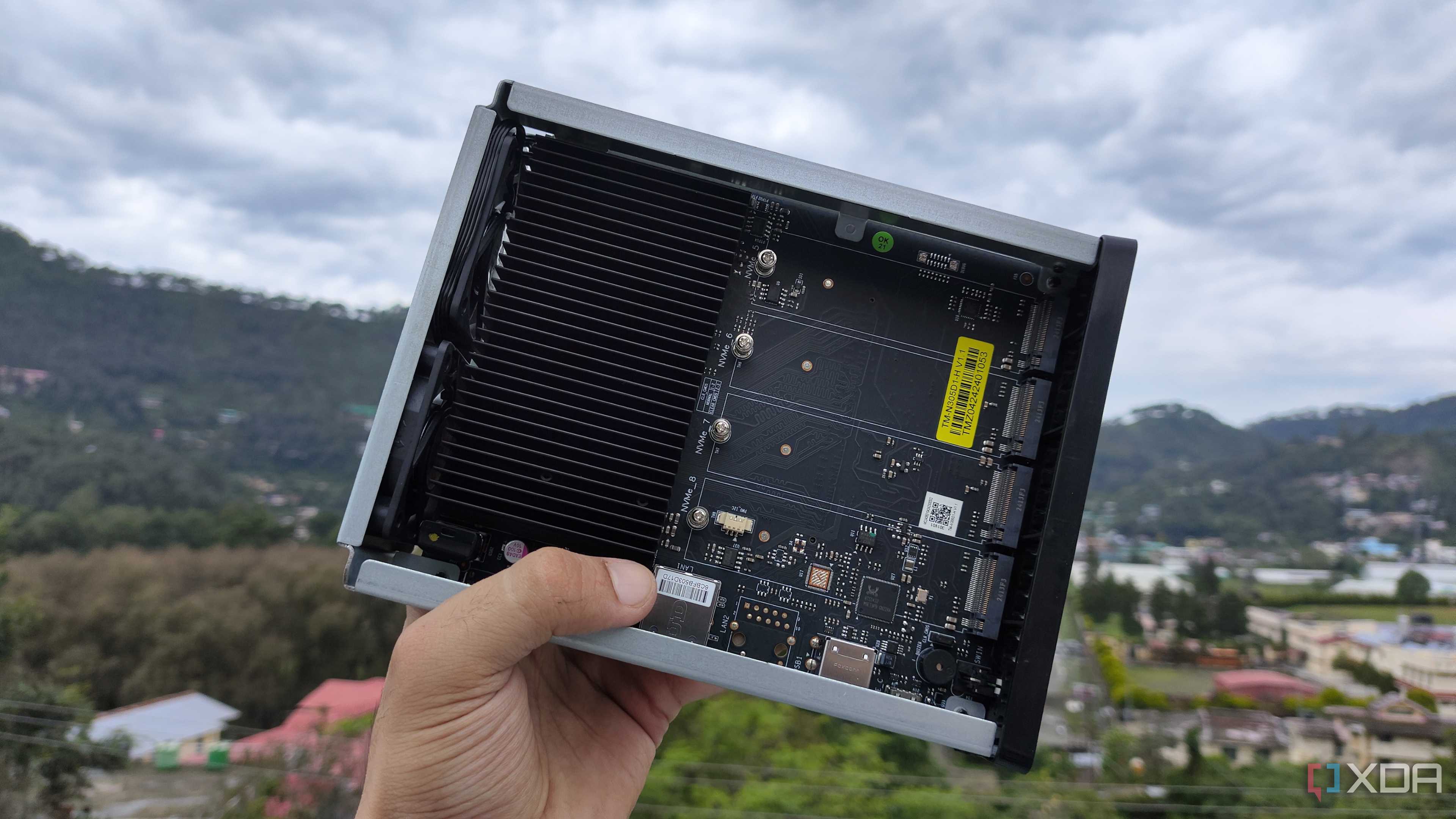 A person holding a TerraMaster F8 SSD Plus NAS