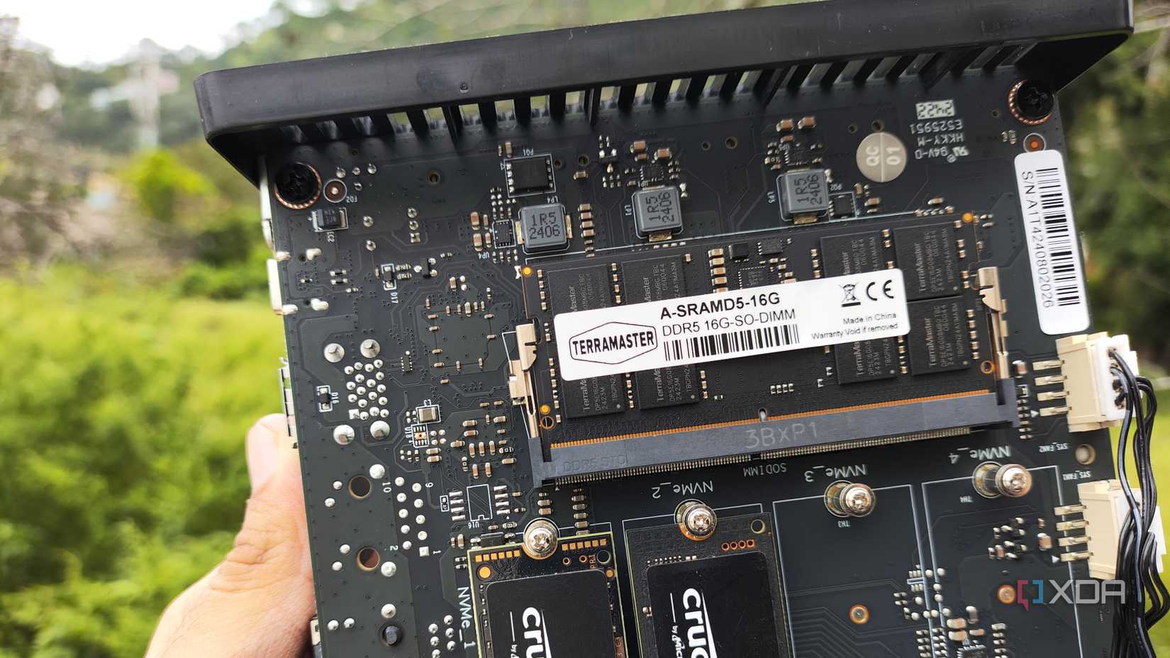 A person holding a TerraMaster F8 SSD Plus NAS