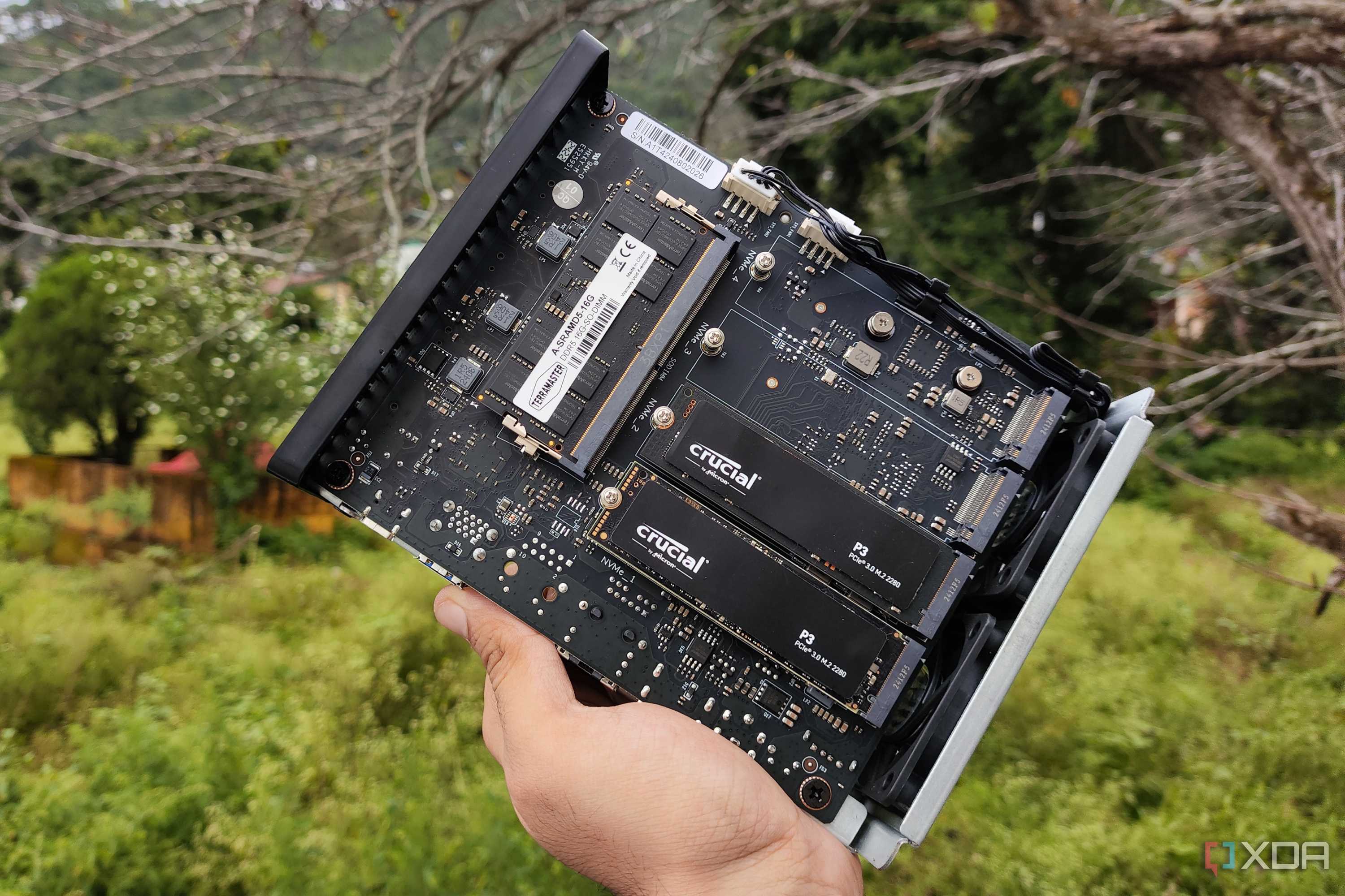 A person holding a TerraMaster F8 SSD Plus NAS