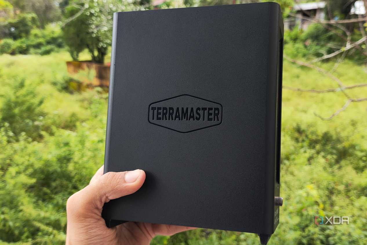 A person holding a TerraMaster F8 SSD Plus NAS