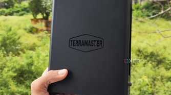 A person holding a TerraMaster F8 SSD Plus NAS