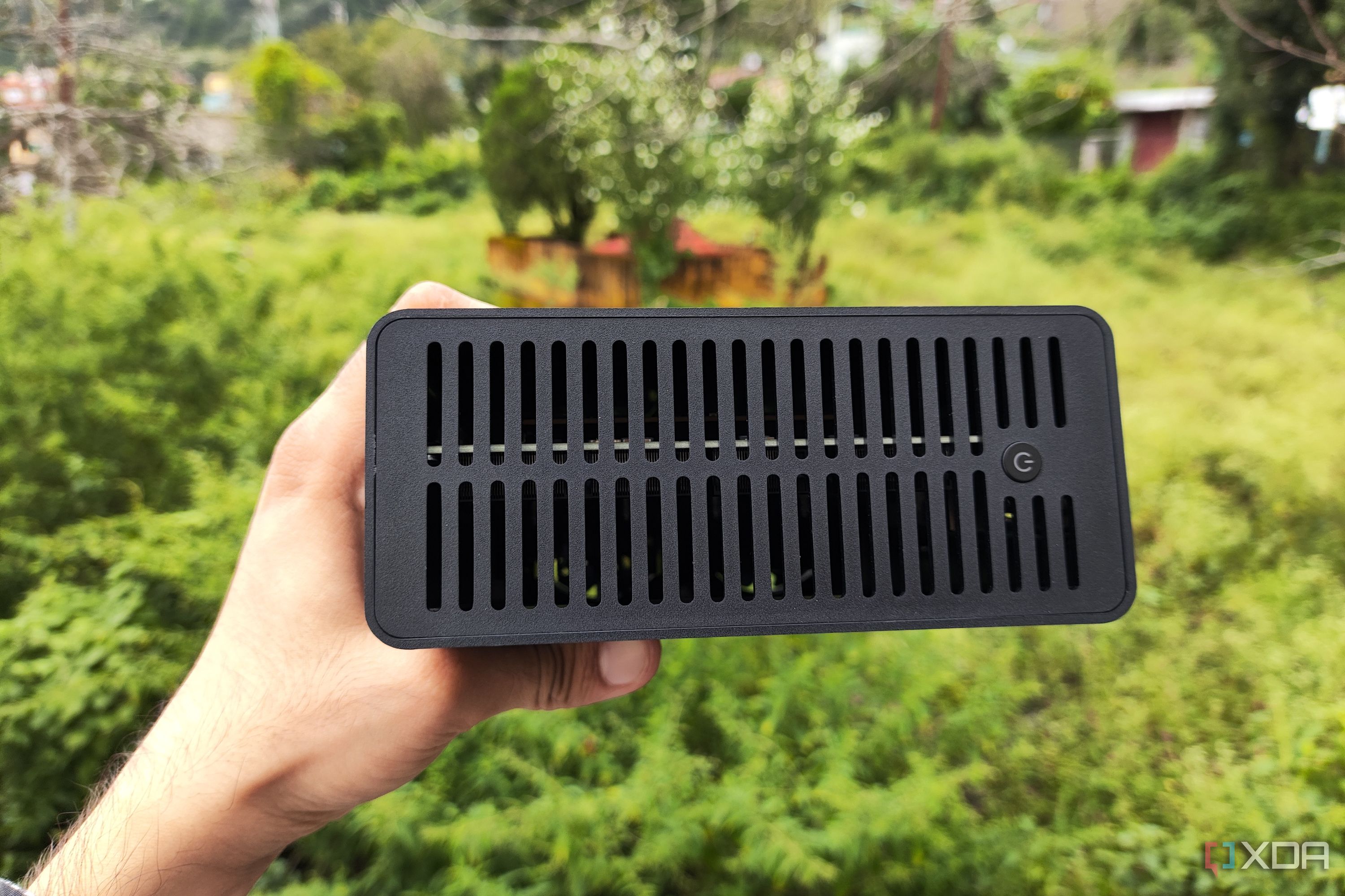 A person holding a TerraMaster F8 SSD Plus NAS