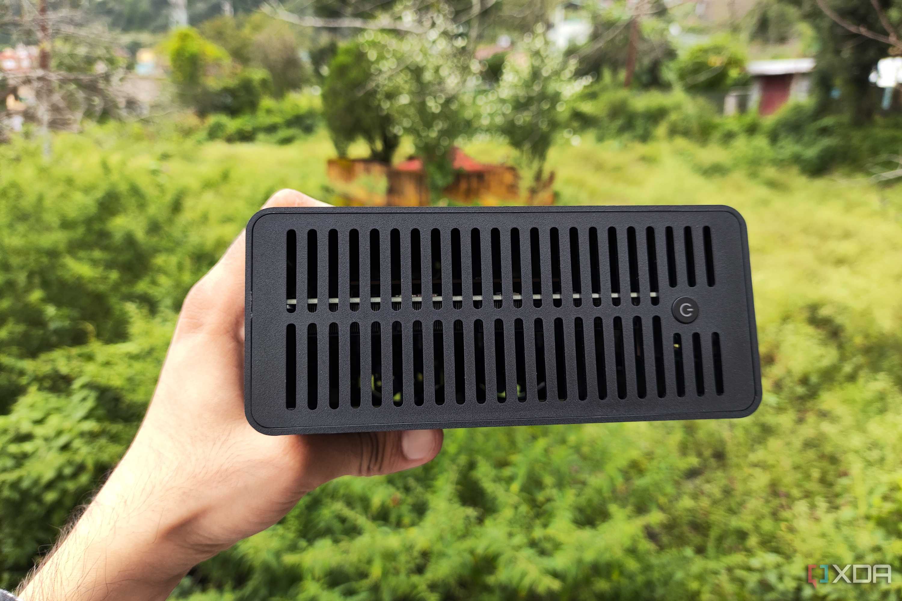 A person holding a TerraMaster F8 SSD Plus NAS