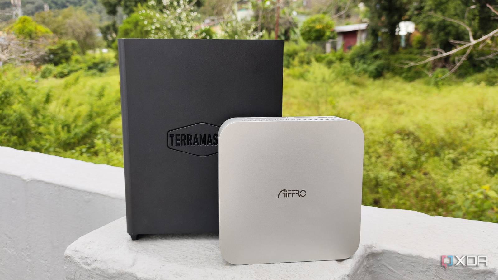 A TerraMaster F8 SSD Plus placed near an Aiffro K100 NAS