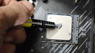 An image of a person applying thermal paste on a Ryzen 5 5600X.