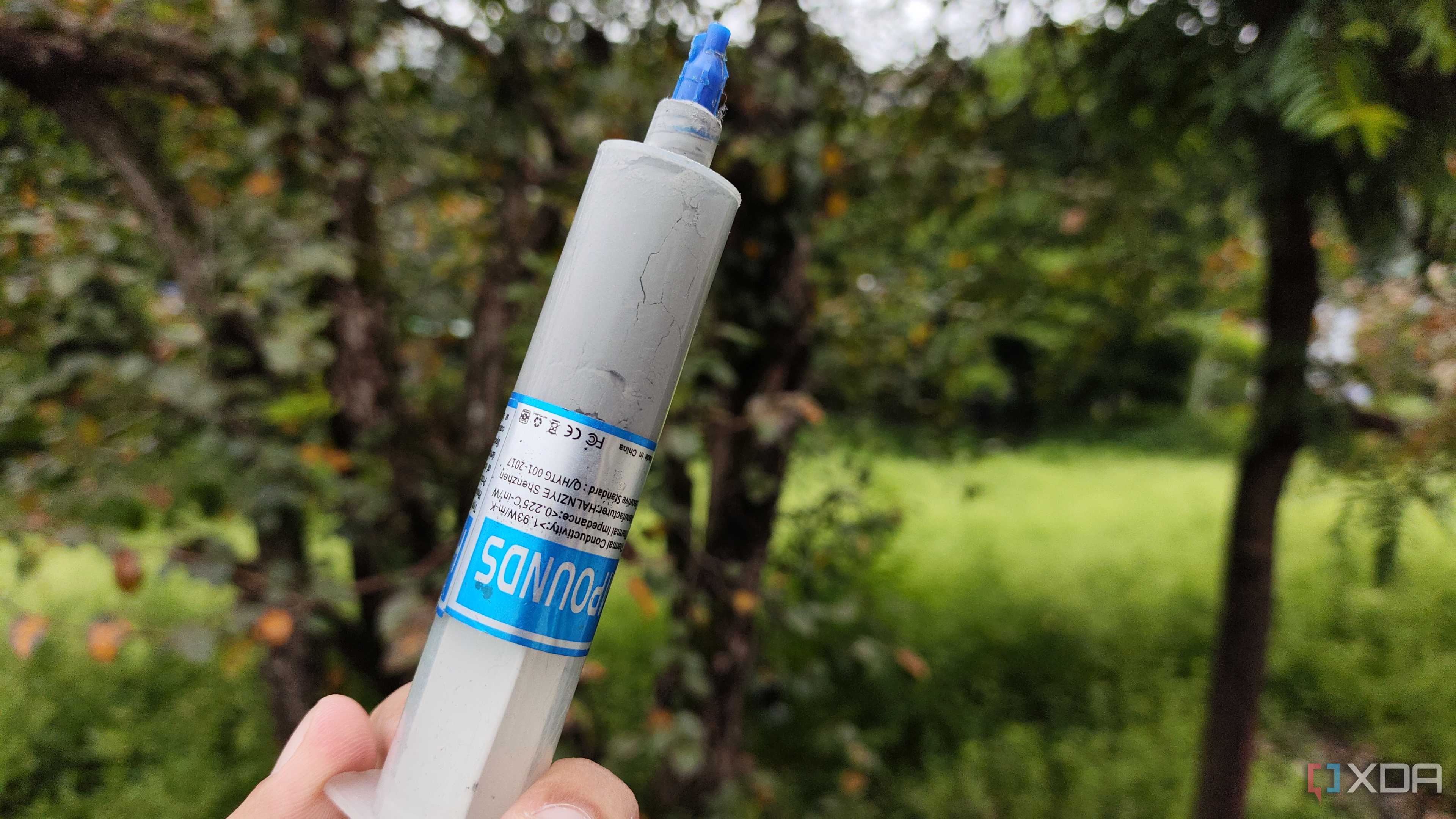 A person holding an Unbranded Thermal Paste
