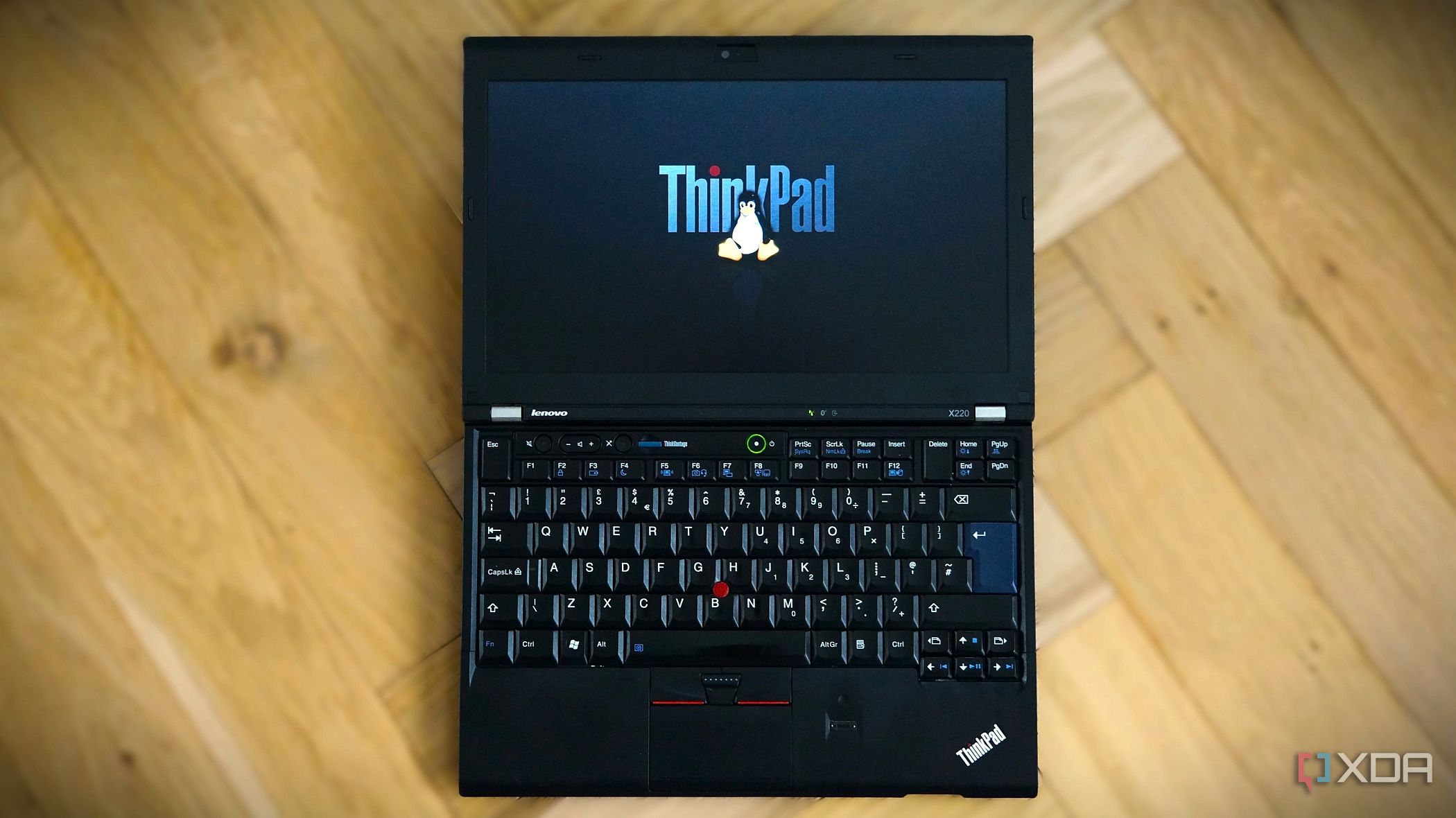 Lenovo x220 with thinkpad logo and linux tux