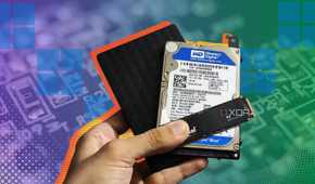 Three storage drives held in someone's hand over a colorful gradient backgrund