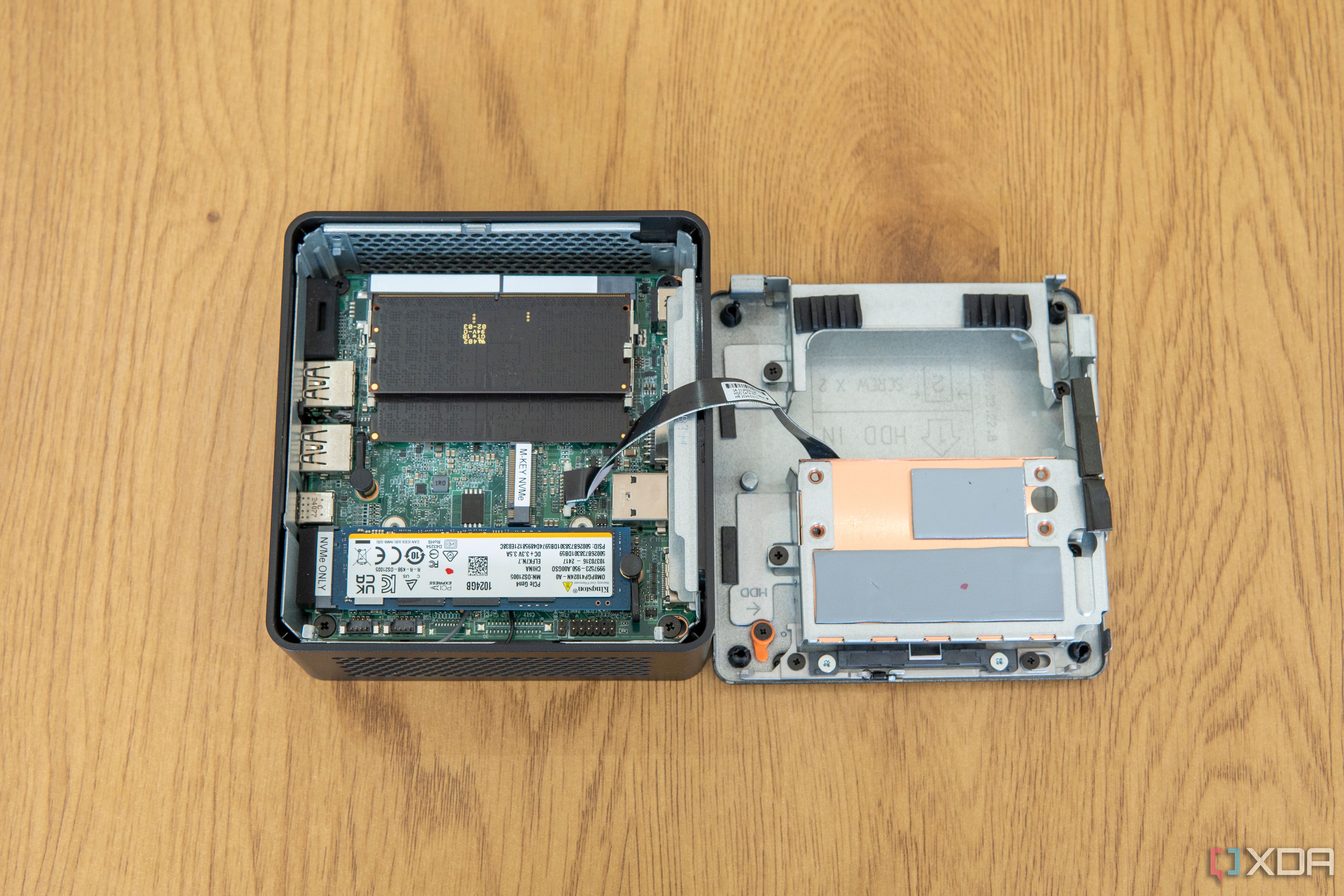 Top-down view of the Asus NUC 14 Pro with the bottom cover and Data drive bay sitting next to it