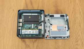 Top-down view of the Asus NUC 14 Pro with the bottom cover and Data drive bay sitting next to it