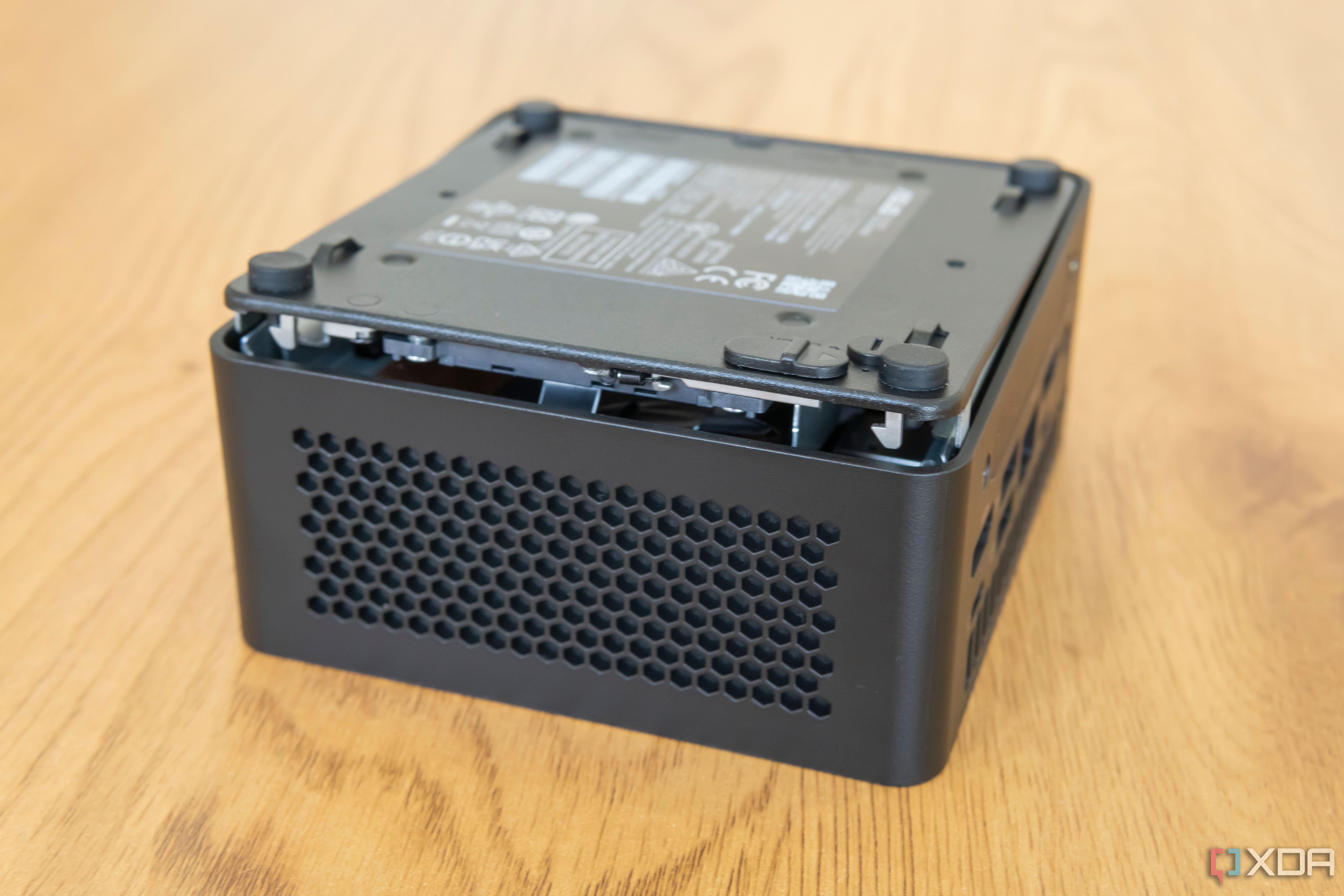 Asus NUC 14 Pro with the bottom cover lifted slightly from the chassis