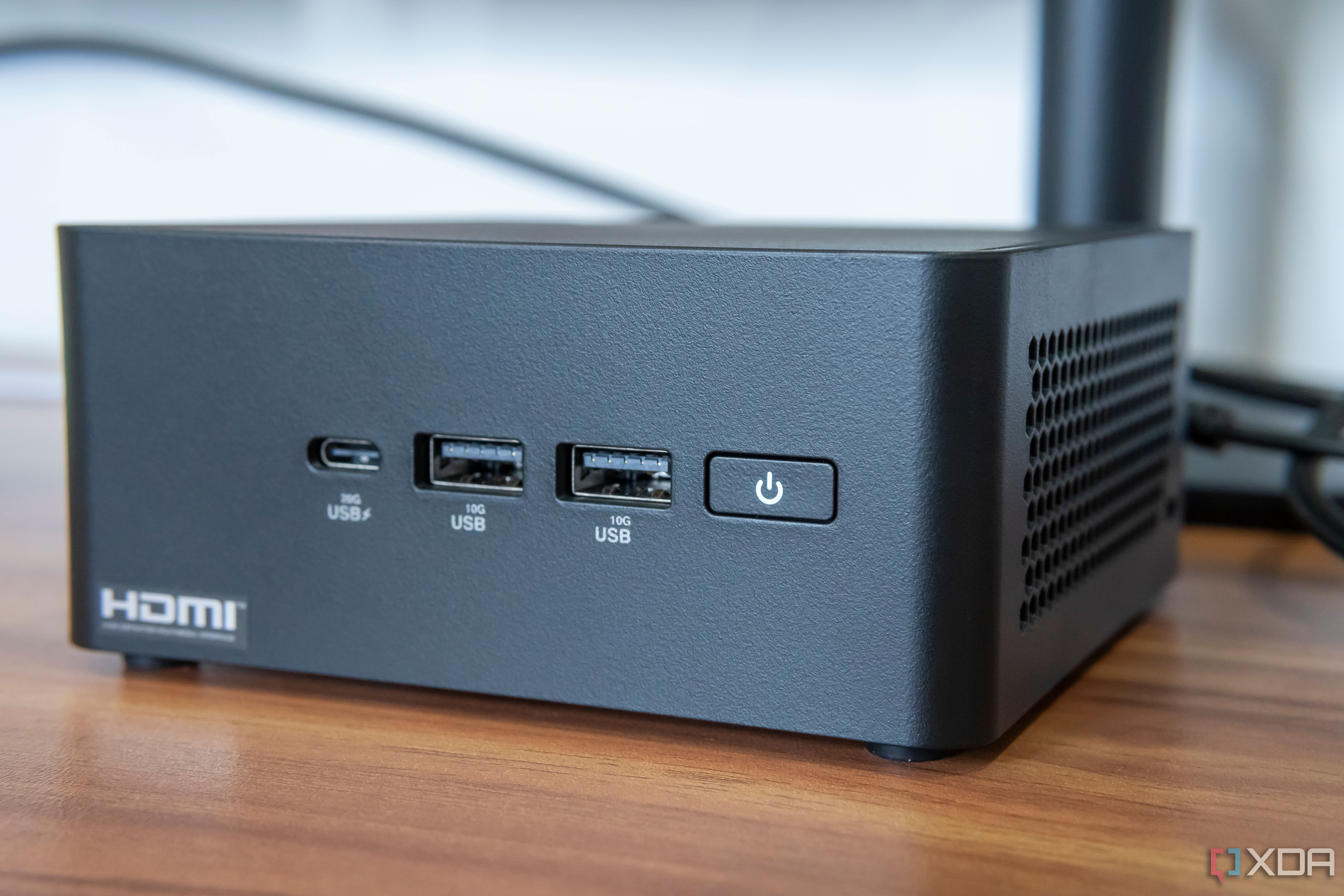 Close-up view of the ports and power button on the front of the Asus NUC 14 Pro