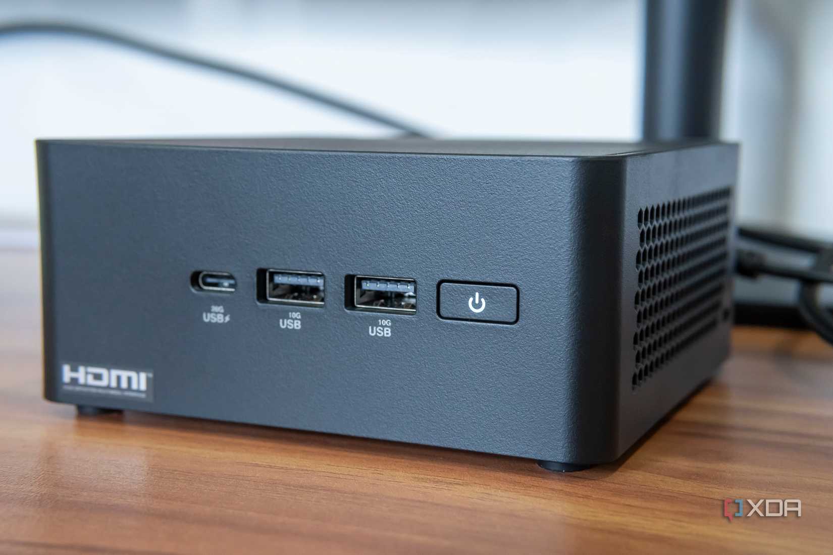 Close-up view of the ports and power button on the front of the Asus NUC 14 Pro
