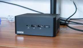 Angled front view of the Asus NUC 14 Pro in front of a monitor stand