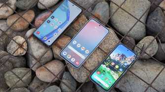 The Samsung Galaxy S24 FE, OnePlus 12R, and the Pixel 8a side by side with large stones in the background