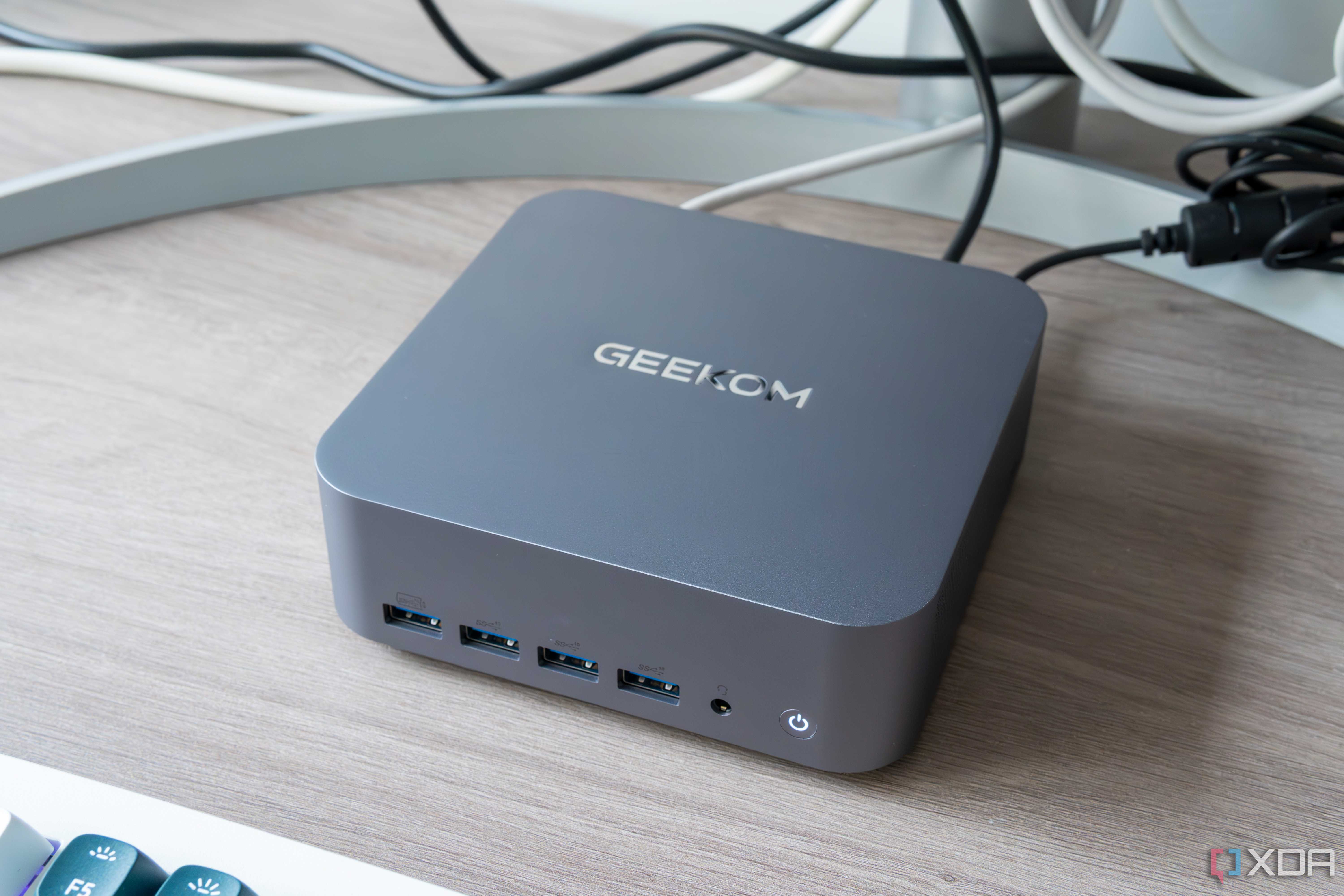 Angled view of the Geekom GT1 Mega next to a monitor and keyboard