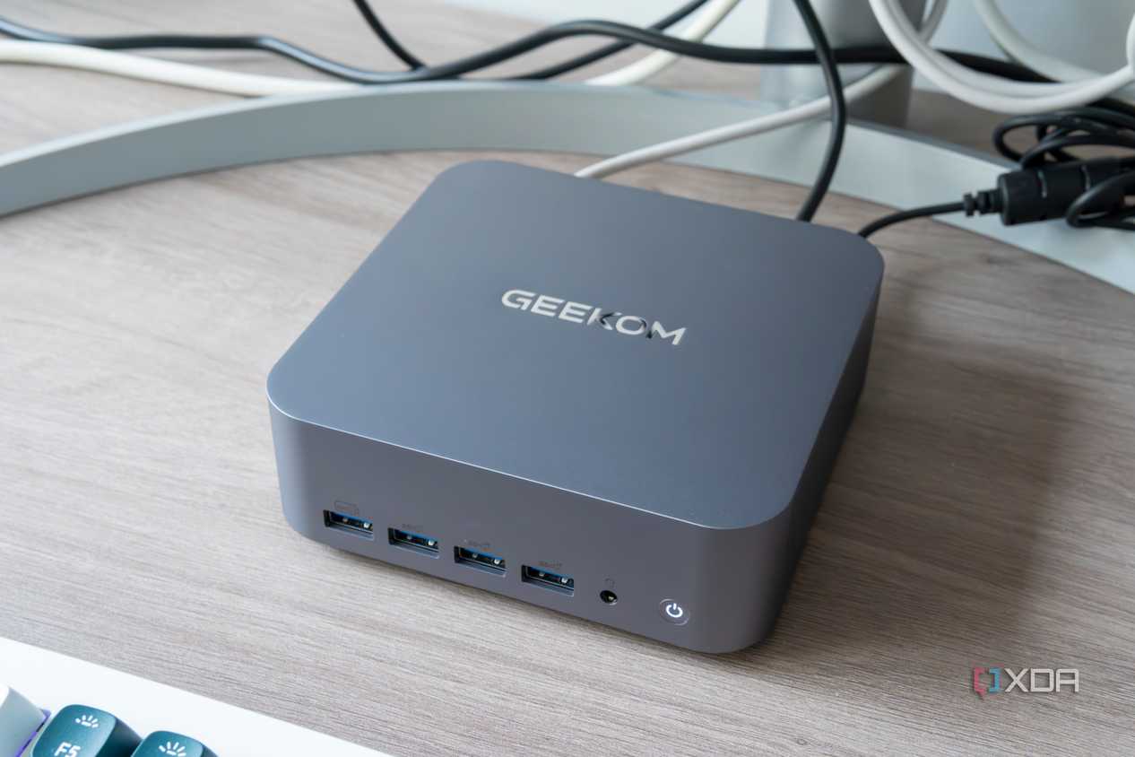 Angled view of the Geekom GT1 Mega next to a monitor and keyboard