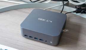 Angled view of the Geekom GT1 Mega next to a monitor and keyboard