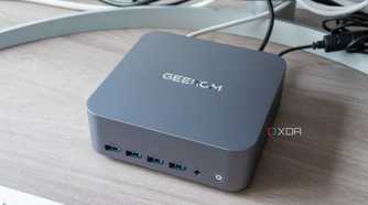 Angled view of the Geekom GT1 Mega next to a monitor and keyboard