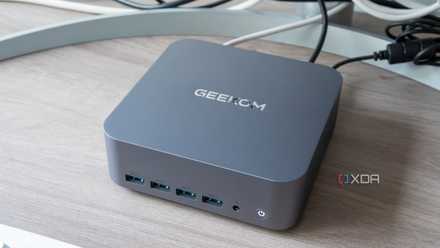 Angled view of the Geekom GT1 Mega next to a monitor and keyboard