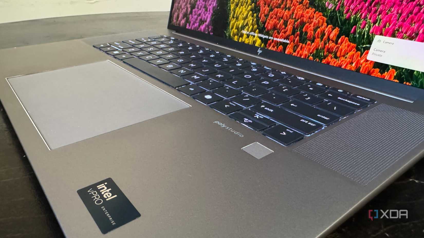 HP ZBook Studio G 11 keyboard and trackpad on a black table