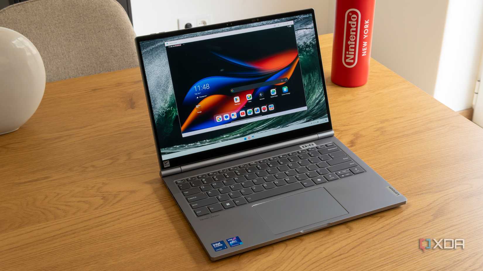 A Lenovo ThinkBook plus Gen 5 Hybrid laptop showing a Windows 11 desktop with the Hybrid Stream app running Android inside of it