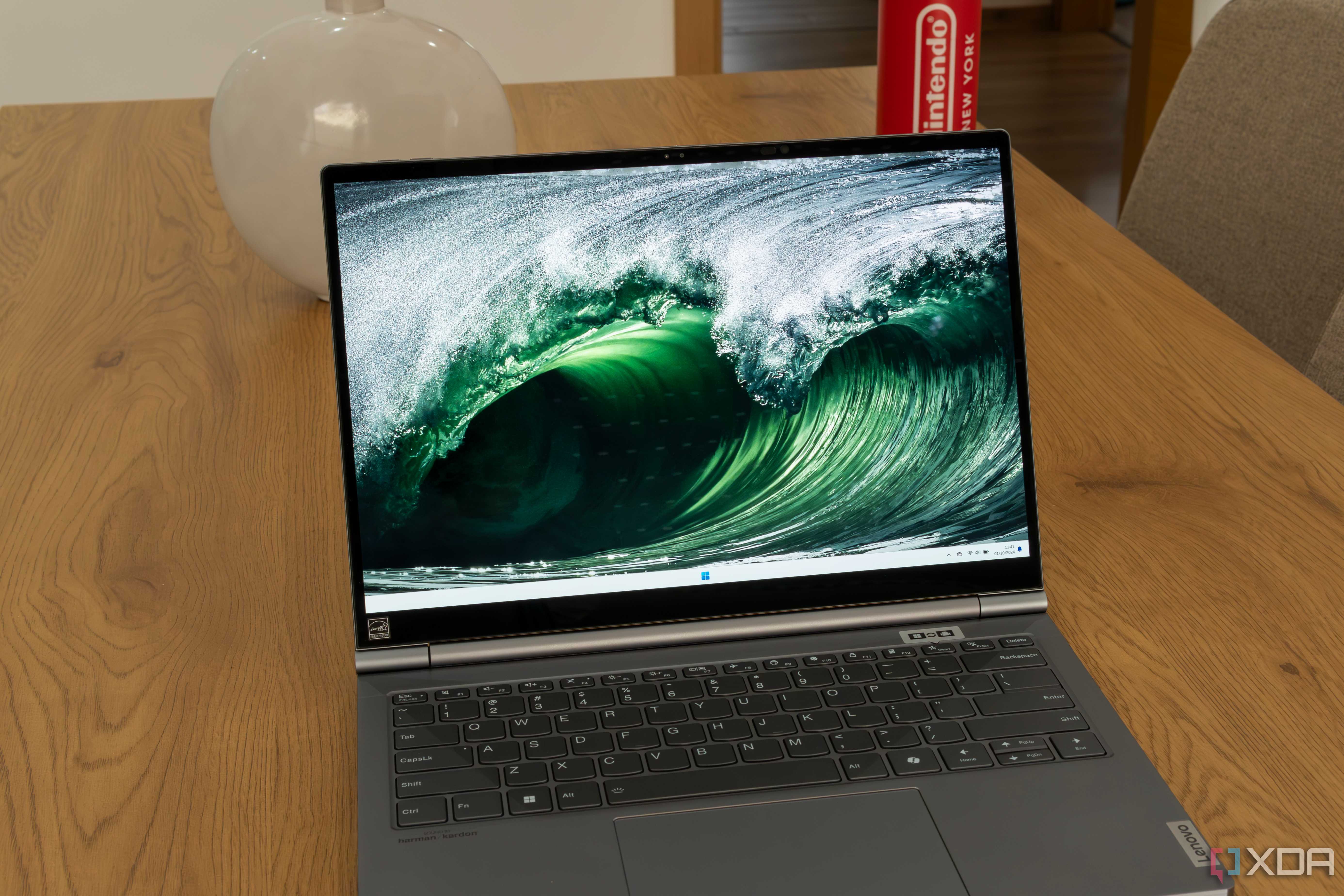 A Lenovo ThinkBook Plus Gen 5 Hybrid displaying a Windows 11 desktop with a background of sea waves