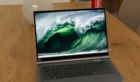 A Lenovo ThinkBook Plus Gen 5 Hybrid displaying a Windows 11 desktop with a background of sea waves