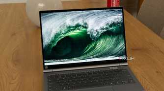 A Lenovo ThinkBook Plus Gen 5 Hybrid displaying a Windows 11 desktop with a background of sea waves