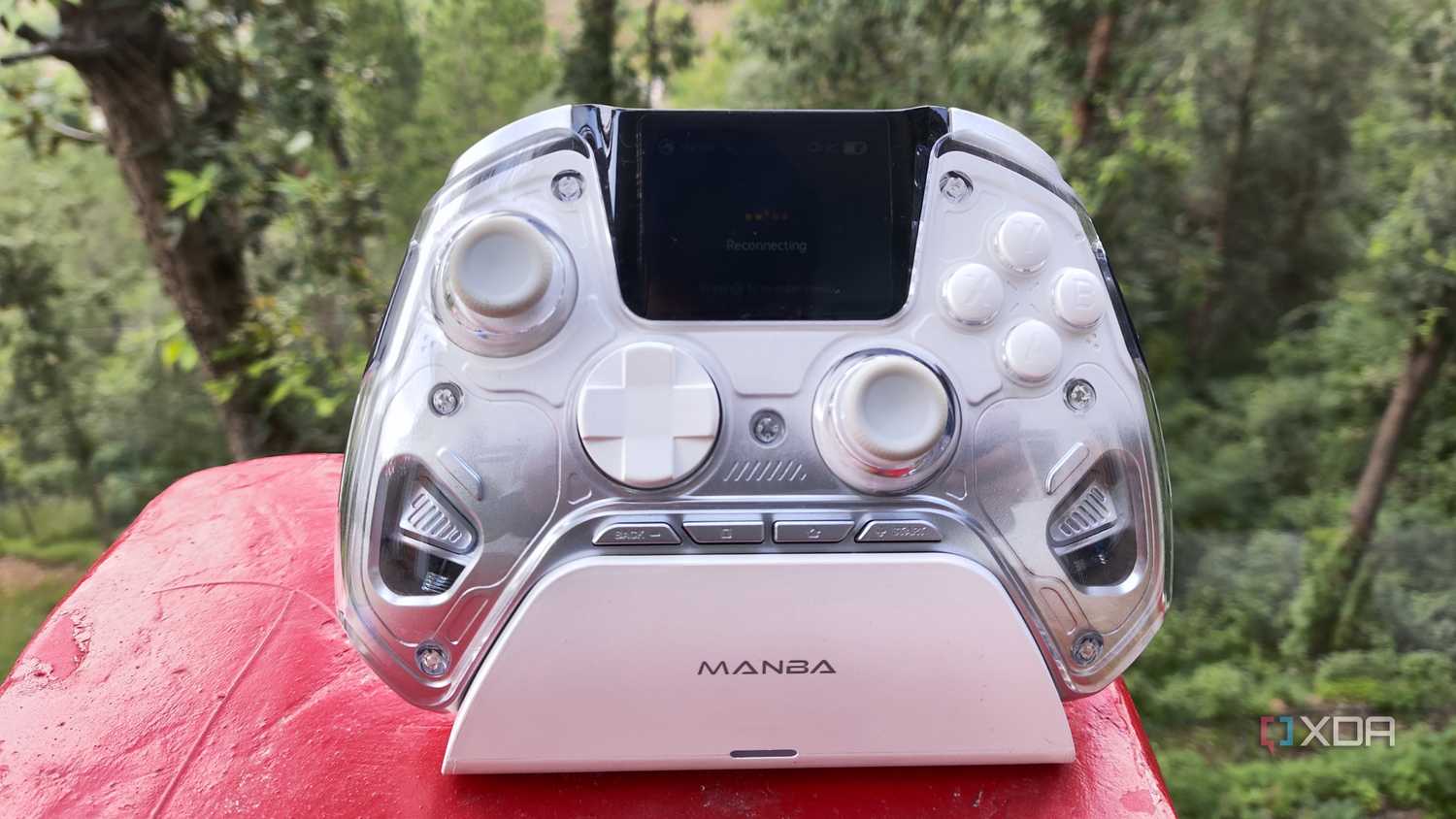 A Manba One controller resting on its charging dock