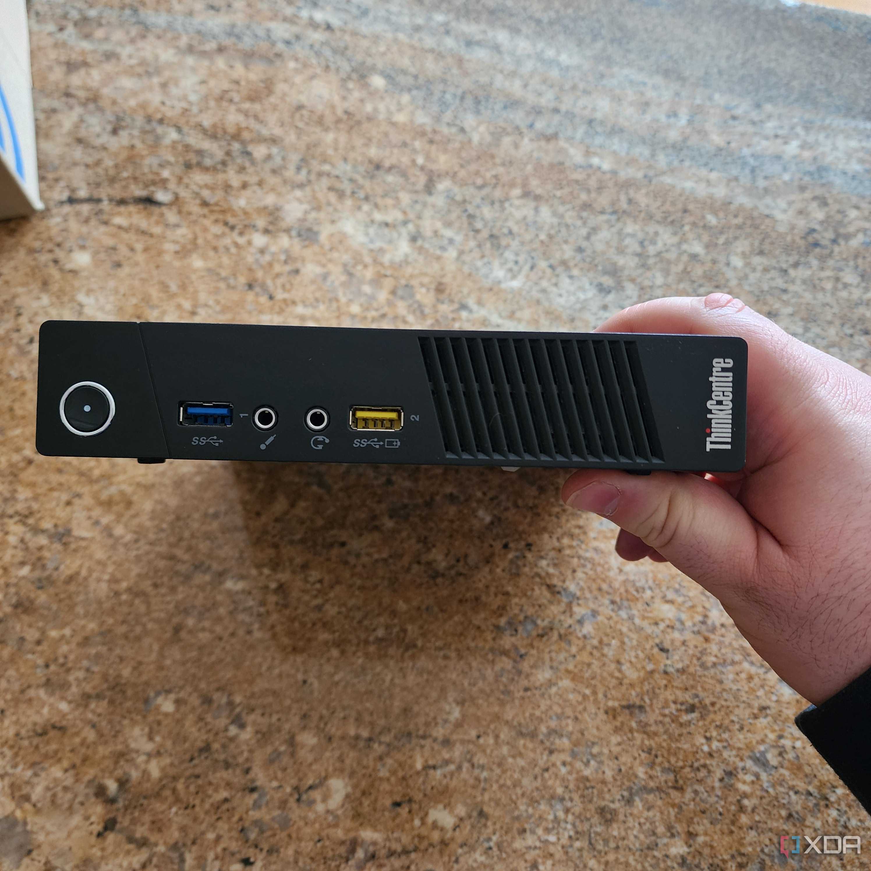 The front panel of a Lenovo mini PC.