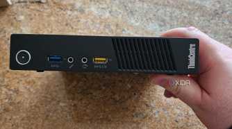 The front panel of a Lenovo mini PC.