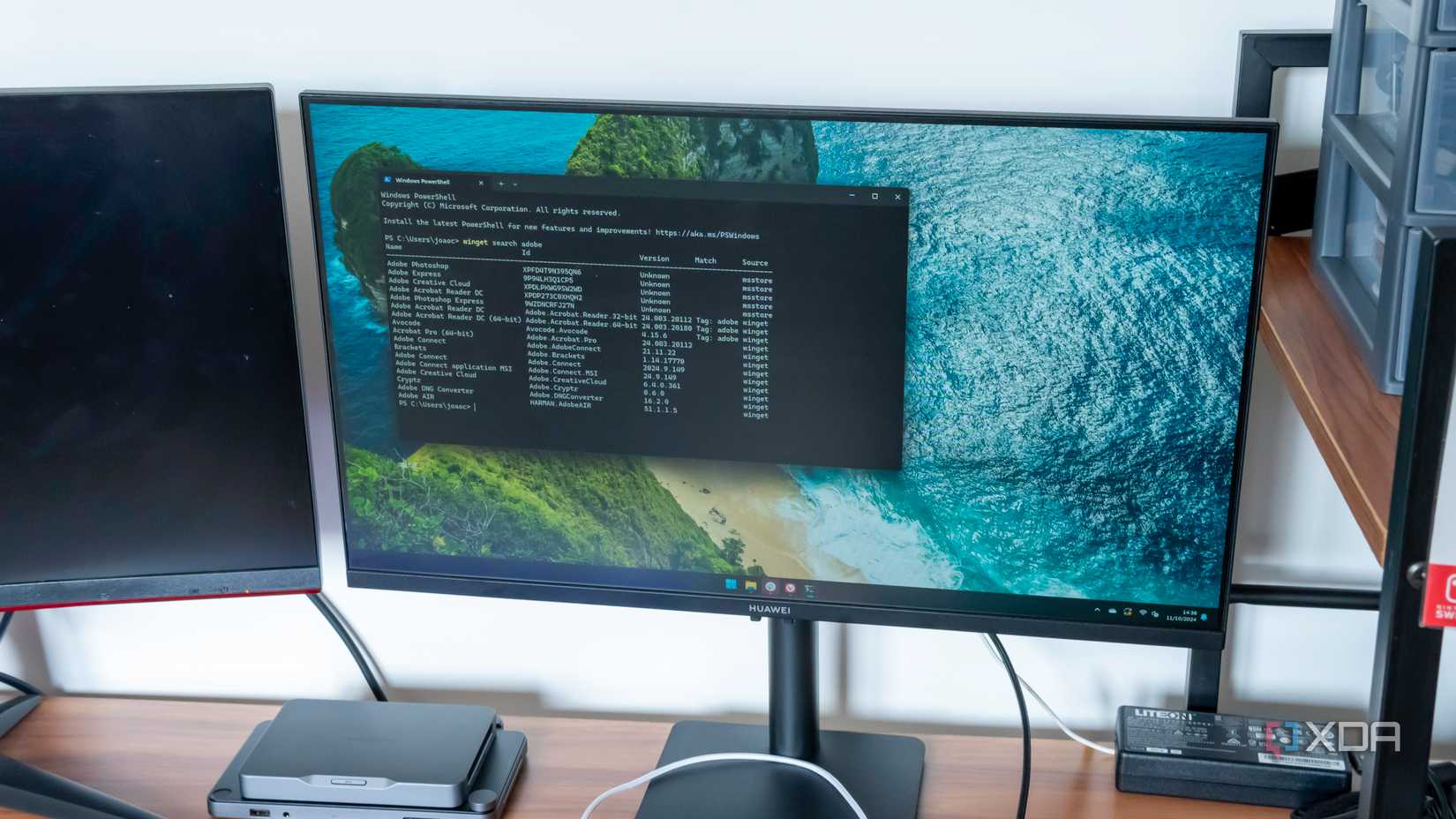 A monitor showing a Windows 11 desktop with winget displaying search results